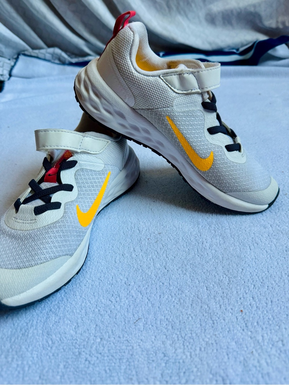 Nike Kids White Sneakers with Yellow Swoosh and Black Accents
